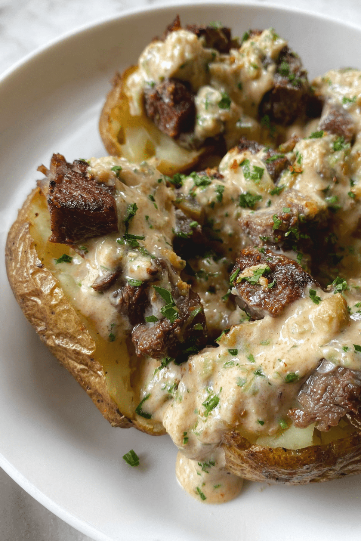 Seak Stuffed Potatoes with Parmesan Cream Sauce